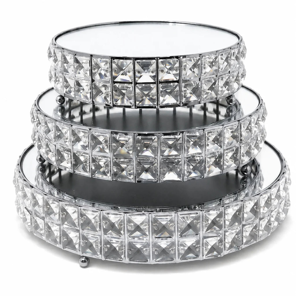 Set of three crystal-studded round trays on a white background