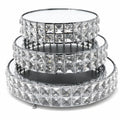 Set of three crystal-studded round trays on a white background