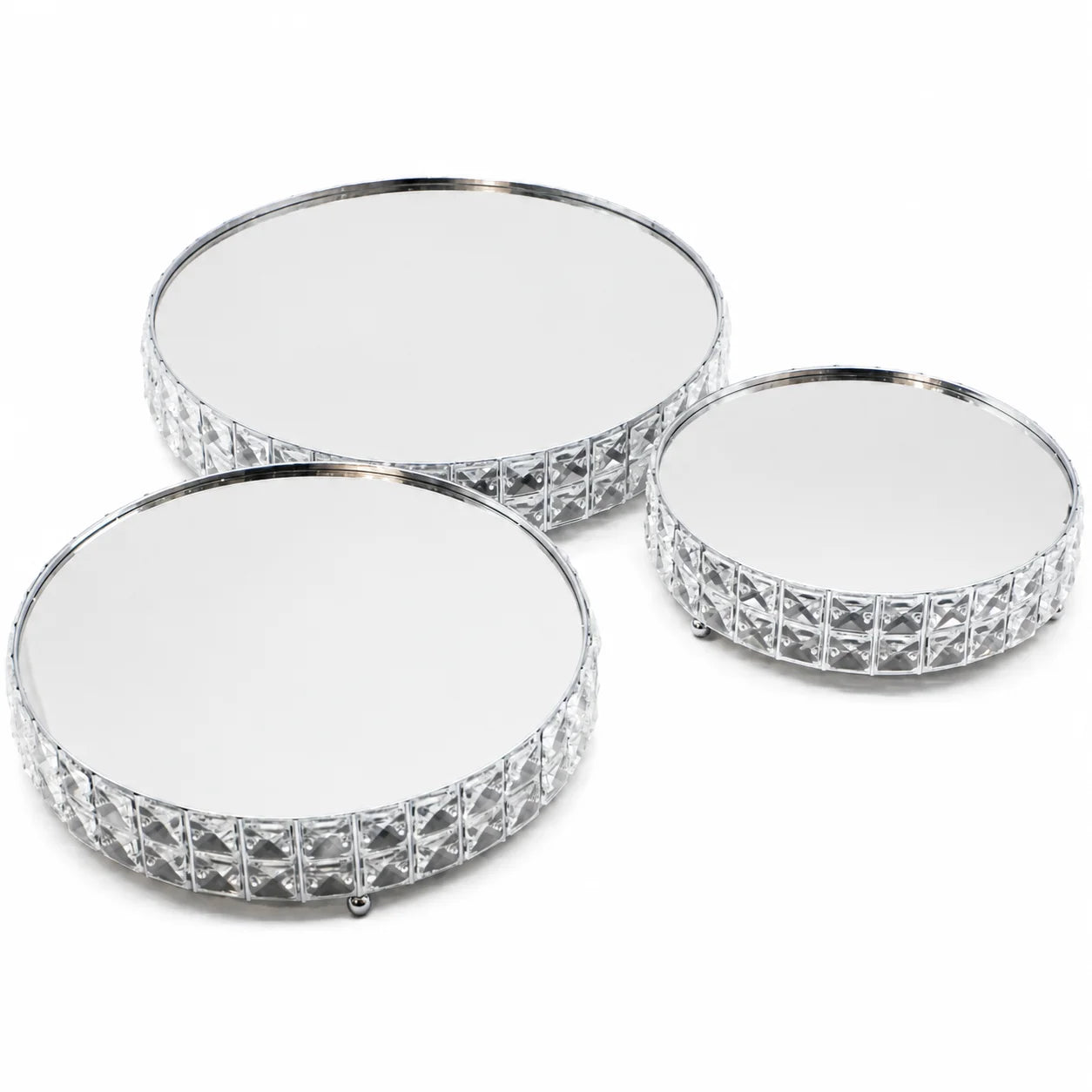 Three round mirrored coasters with decorative silver edge on a white background