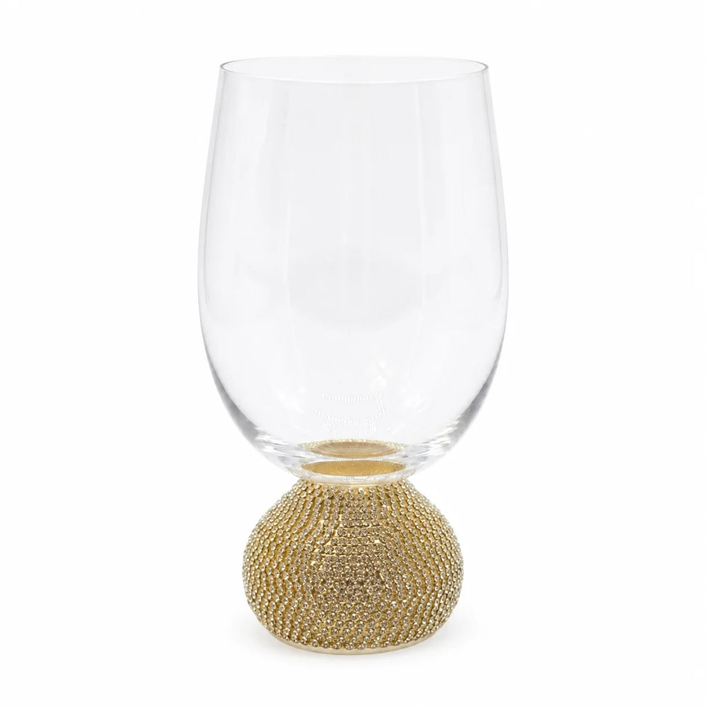 Clear glass wine glass with gold base on a white background