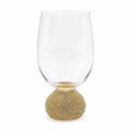 Clear glass wine glass with gold base on a white background