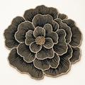 A large circular floral design with layered petals in black and beige, featuring fine line details and a textured center, shown on a plain light background.