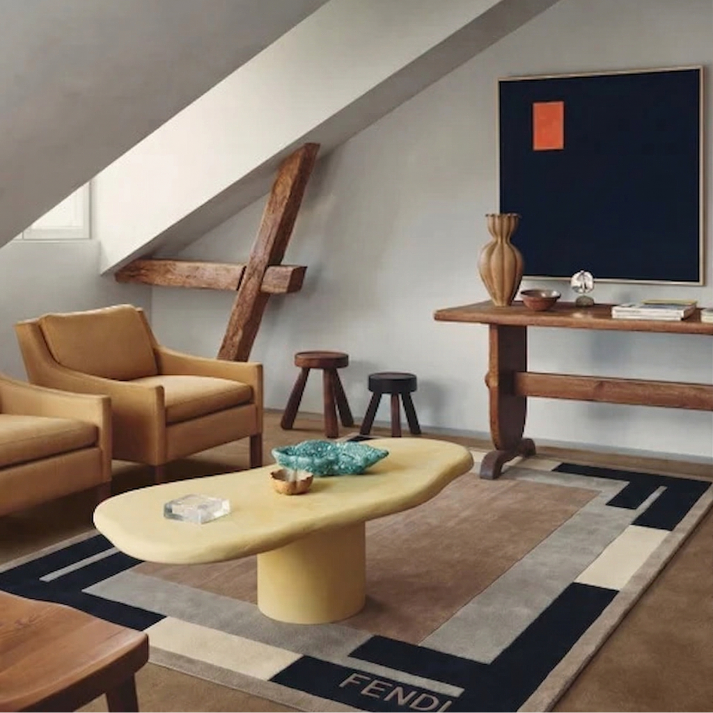Modern living room with brown armchair, yellow coffee table, and Fendi rug.