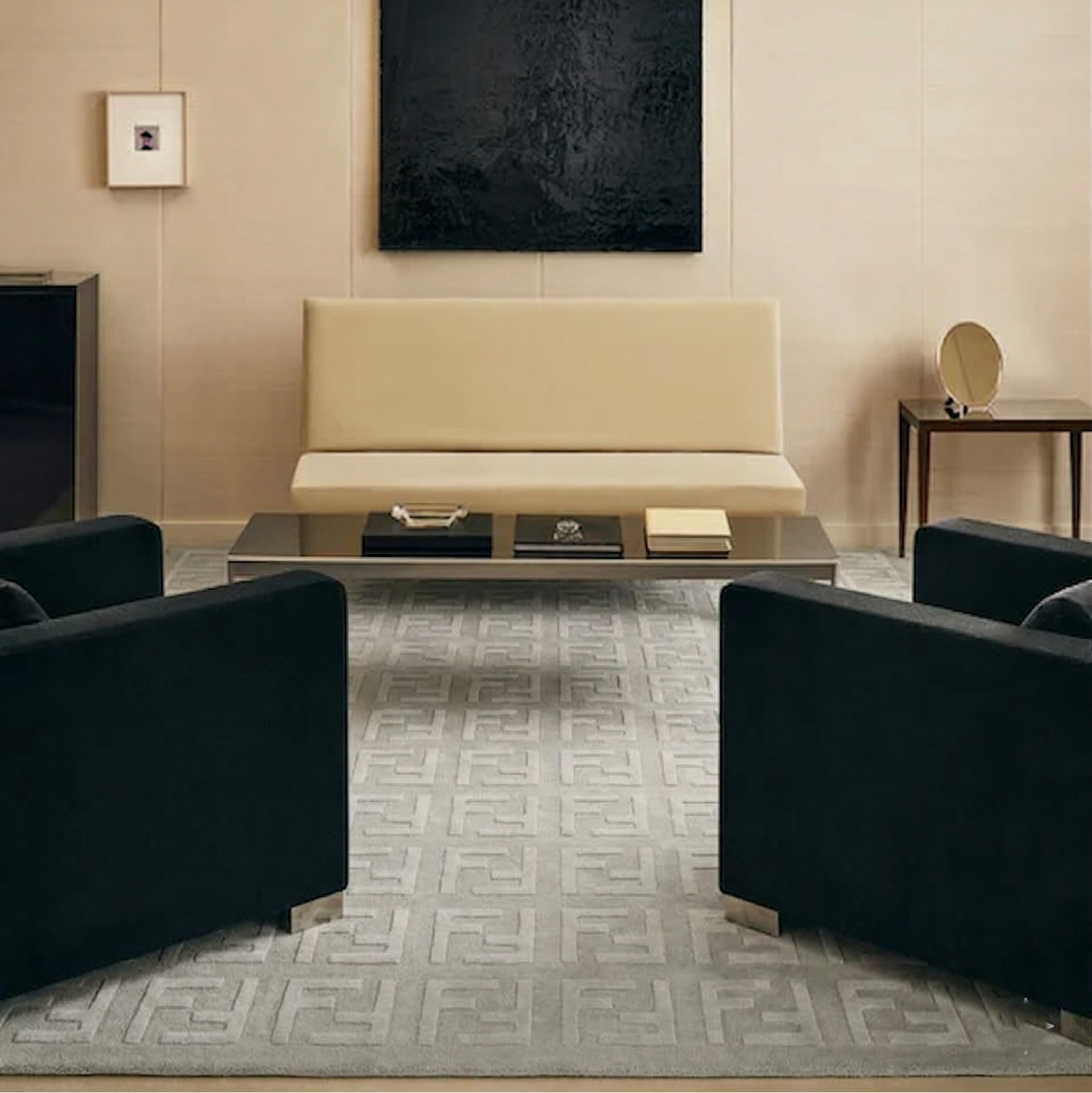 Modern living room with beige sofa, black chairs, and abstract art on the wall.
