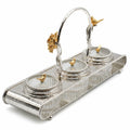 Silver inkwell set with gold bird accents on a white background