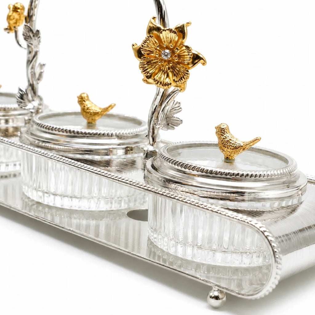 Decorative silver and gold container set on a white background