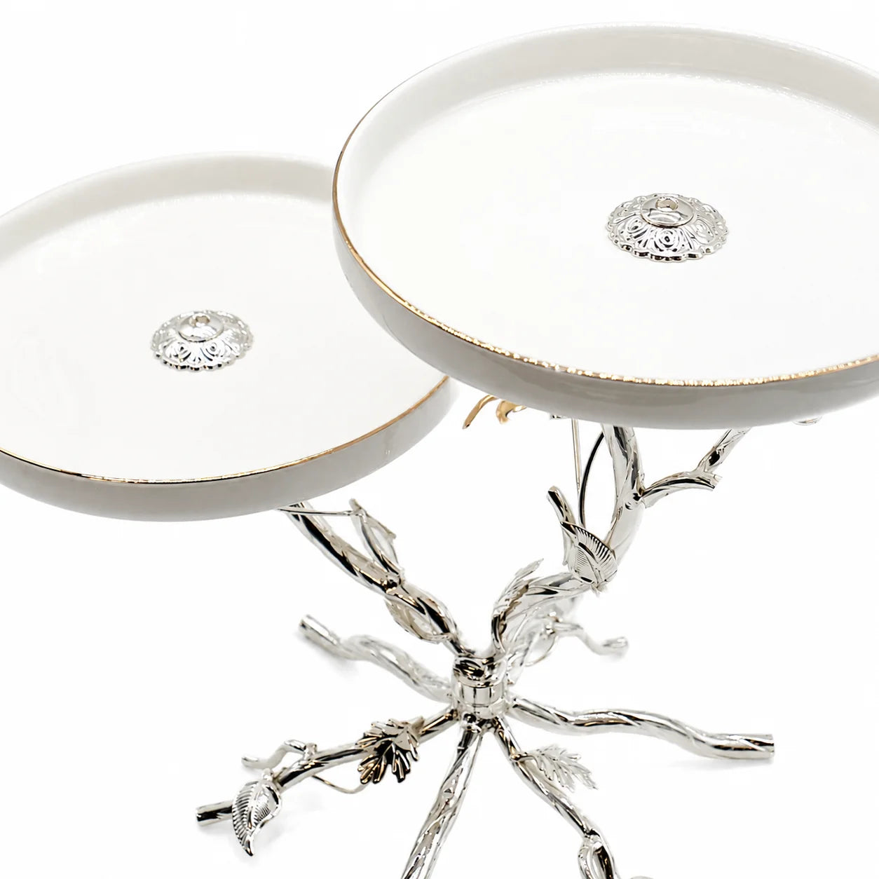 Decorative silver stand with branch-like design on a white background