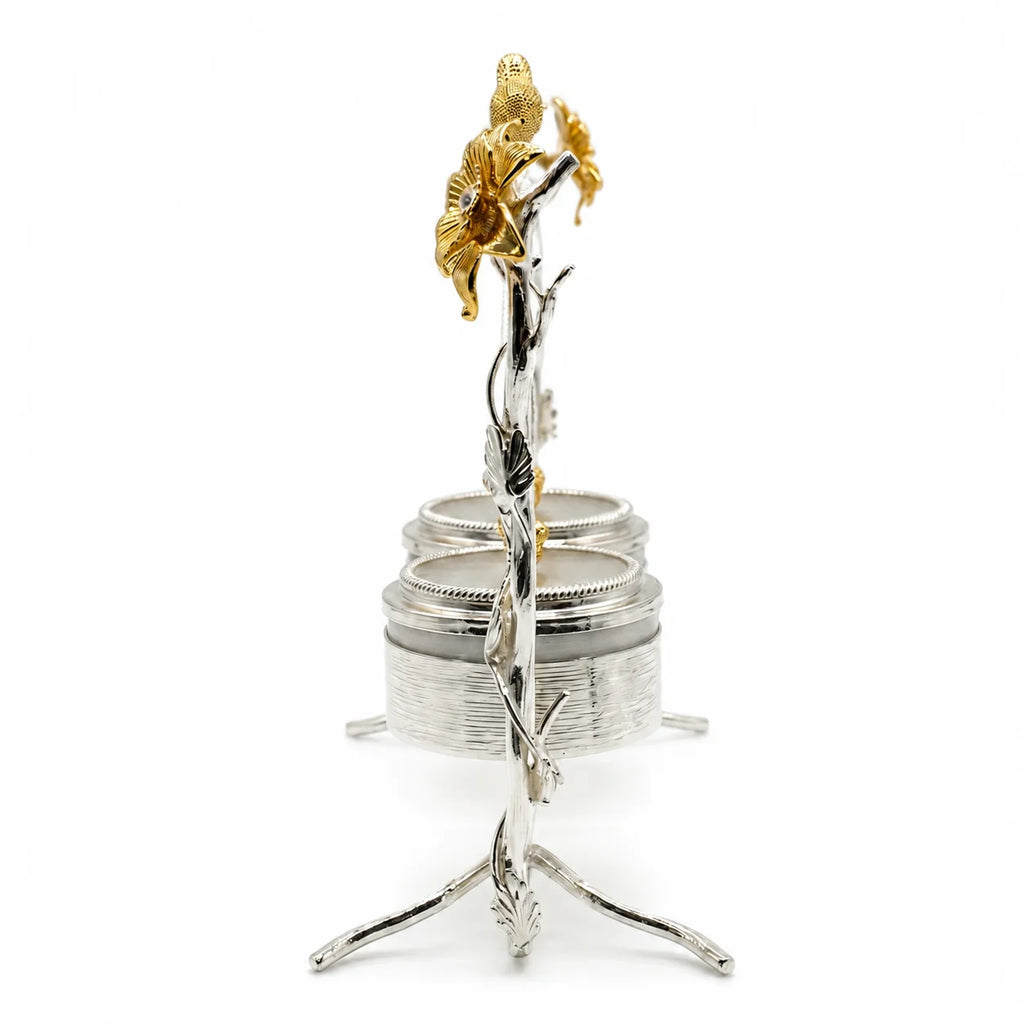 Decorative silver and gold flower sculpture on a white background