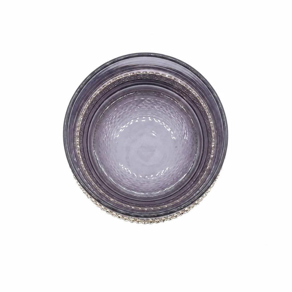 Round glass plate with textured rim on a white background