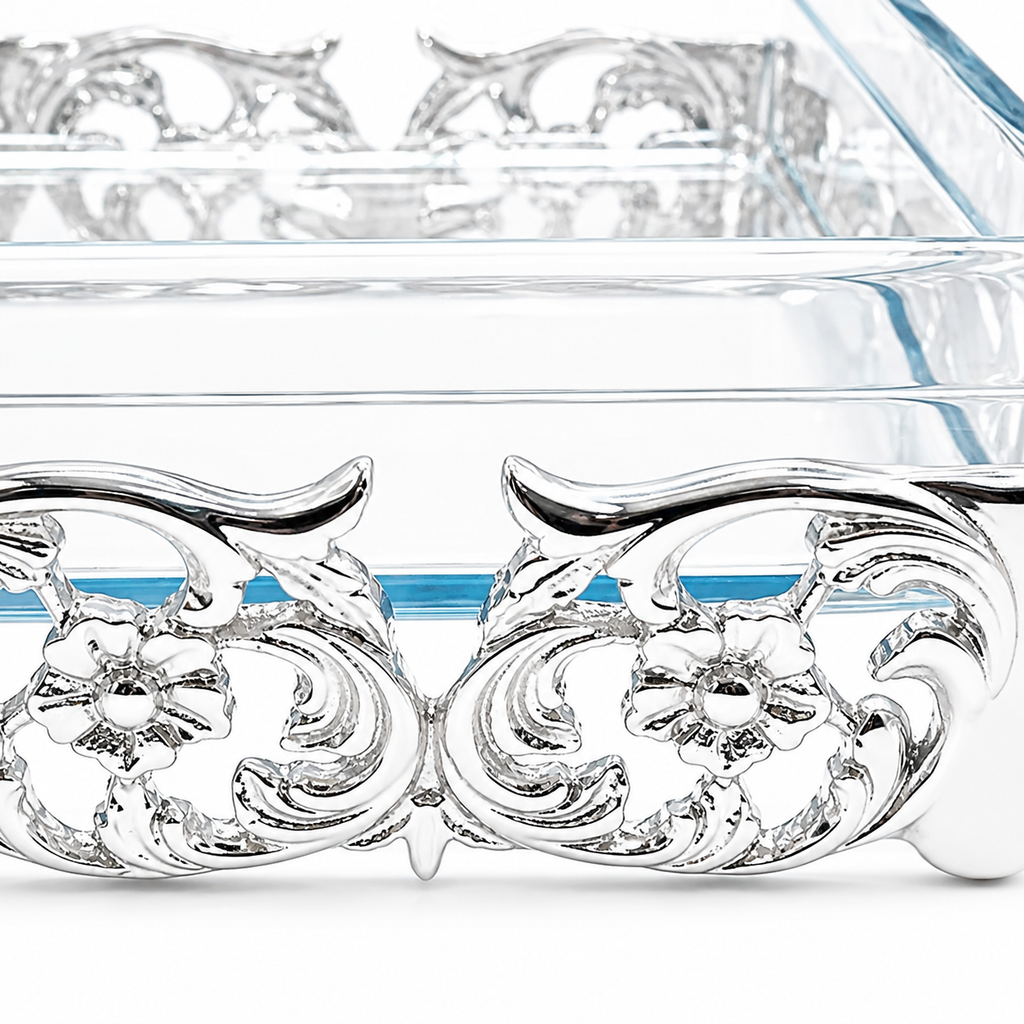 Decorative glass container with silver embellishments on a white background