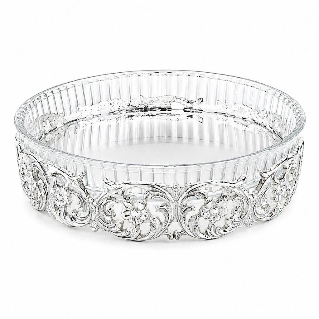 Decorative silver bowl with intricate patterns on a white background