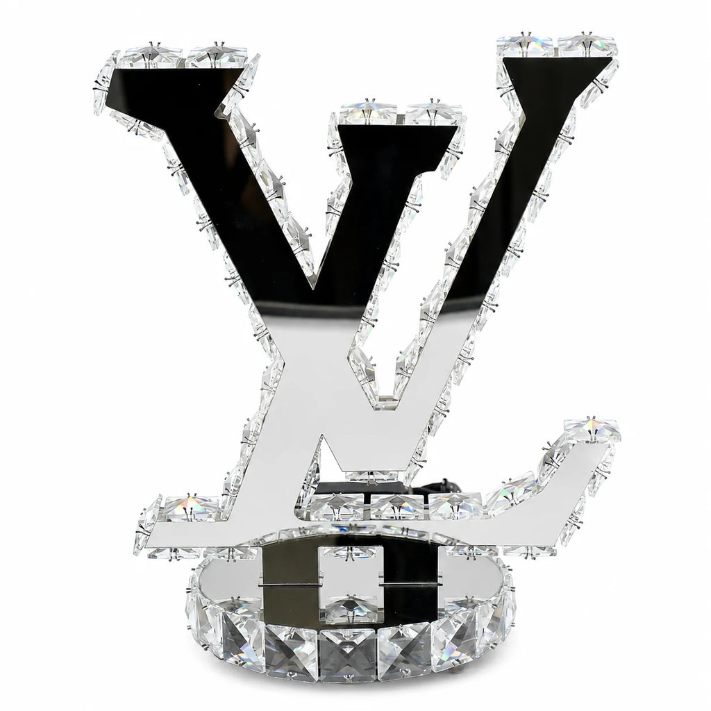 Decorative letter 'V' with crystals on a white background