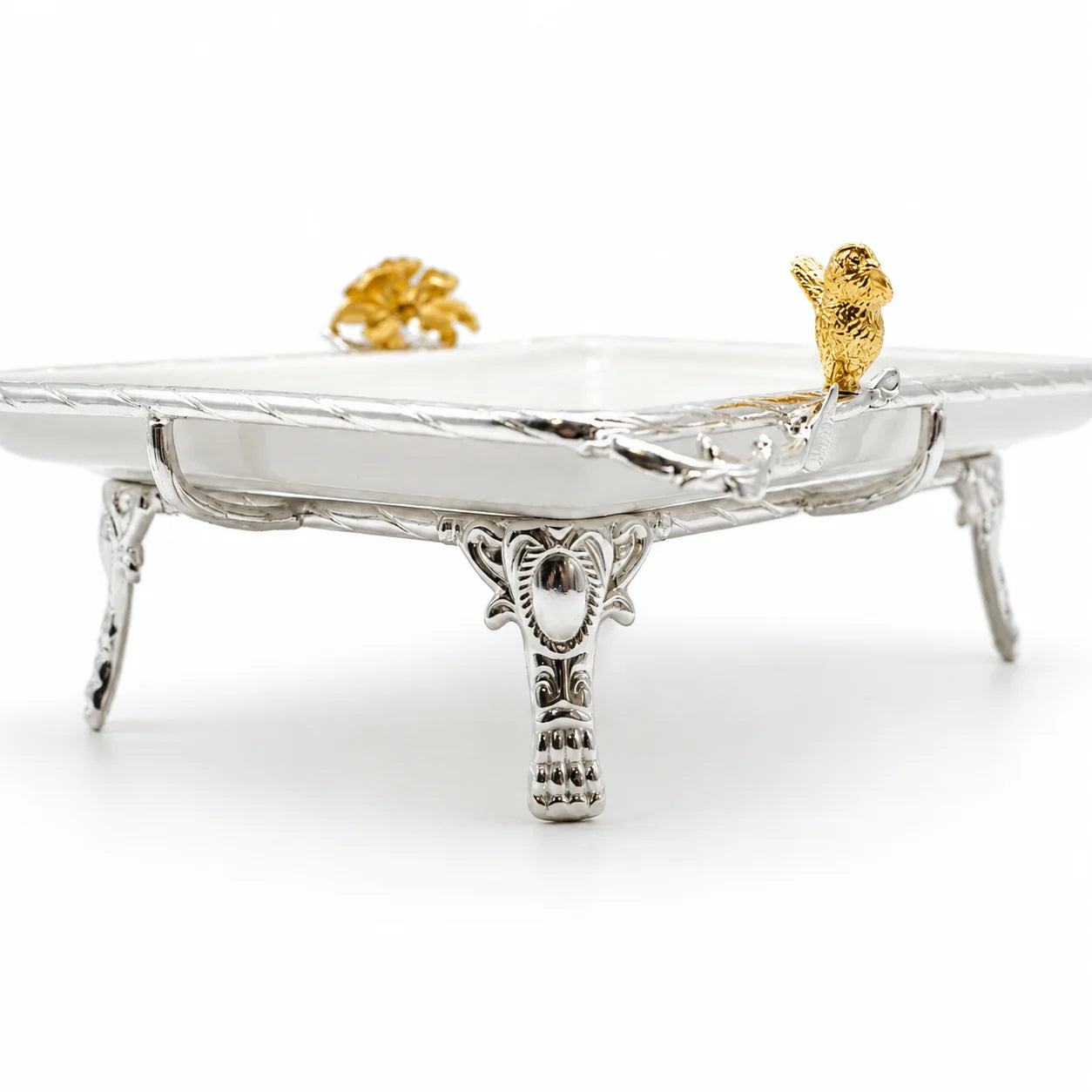 A rectangular white ceramic serving tray with a twisted silver-tone metal border.