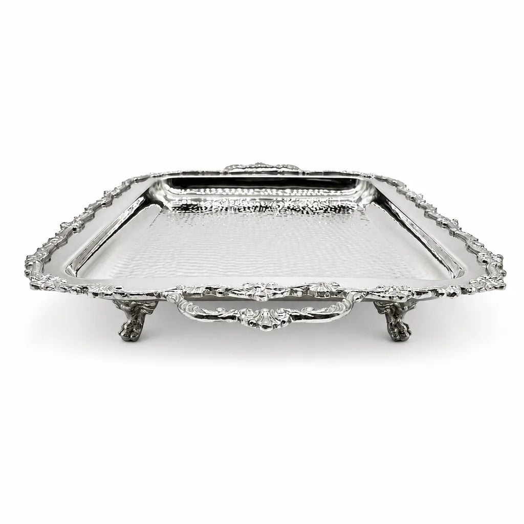 A rectangular silver serving tray with ornate claw feet, a hammered texture, and a decorative handle, shown on a plain white background.