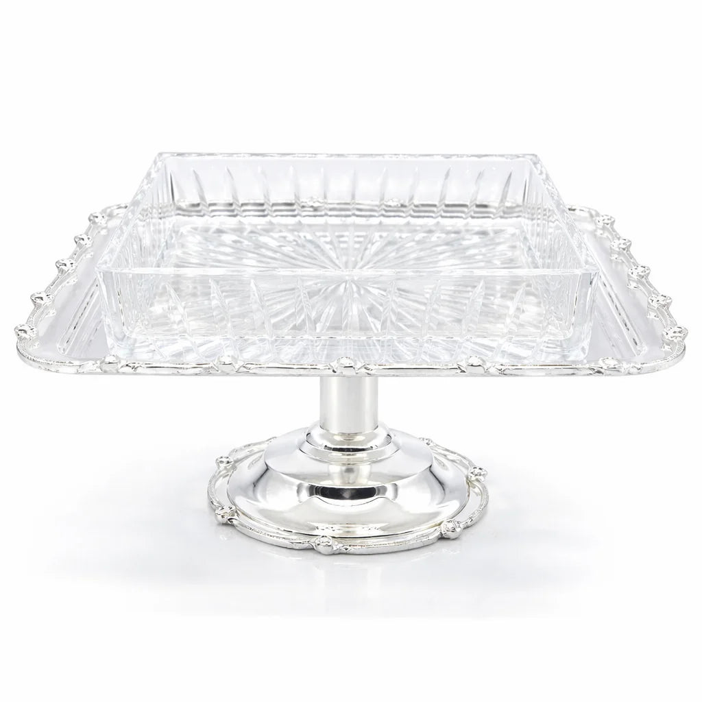 Clear glass cake stand with silver base on a white background