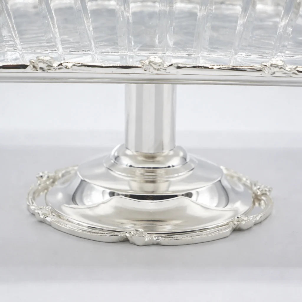 Silver pedestal dish with clear glass top on a white background