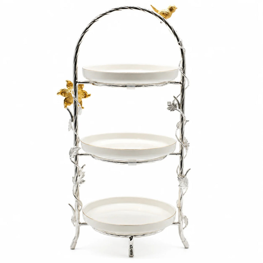 Three-tiered decorative stand with white plates and gold butterfly accents on a white background