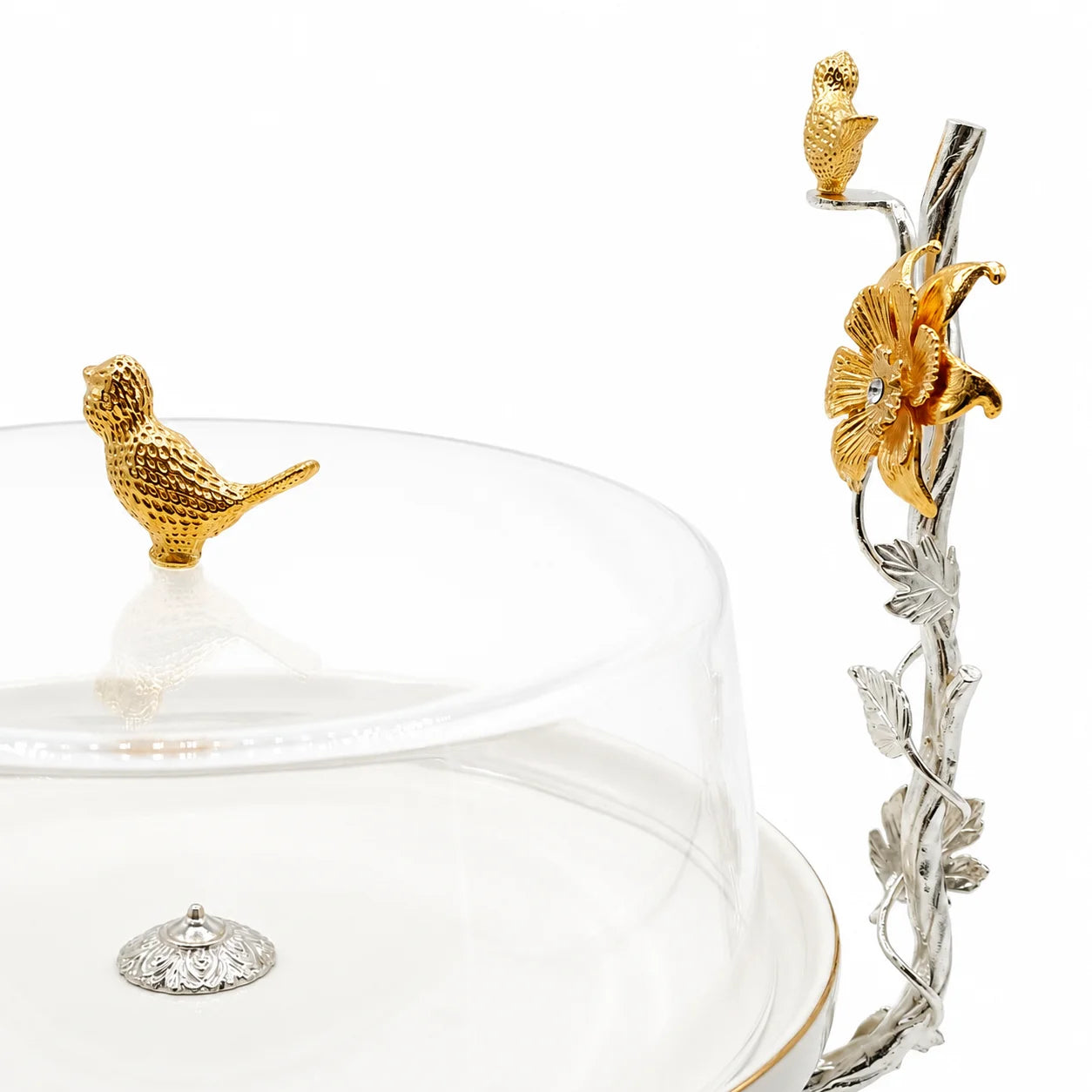 Decorative glass dish with gold bird and floral accents on a white background