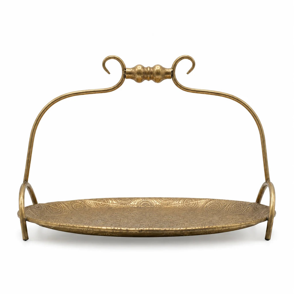 Decorative gold metal stand with curved handle on a white background